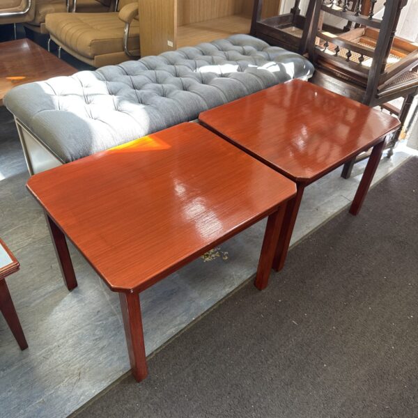 Pair of vintage painted side tables in a room setting.