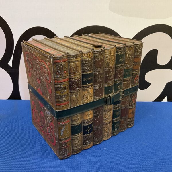 Antique Huntley & Palmers biscuit tin shaped like a stack of books.