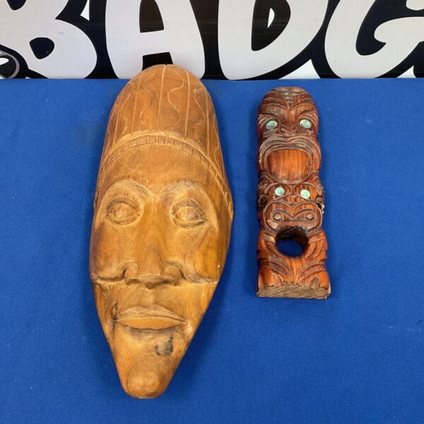 Detailed Maori carved wooden mask from New Zealand, showcasing traditional artistry.