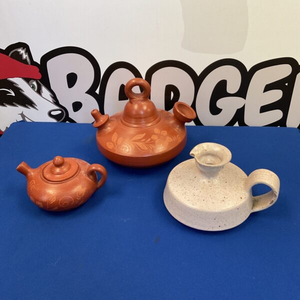 Vintage terracotta water cooler and teapot set for rustic kitchen decor.