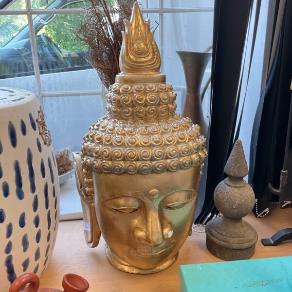 Large gold Buddha head sculpture for home decor.