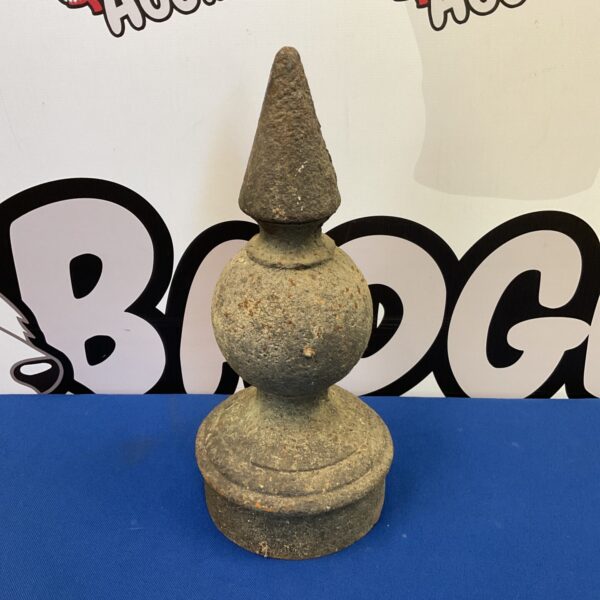 Antique cast iron finial with tiered design and weathered patina.