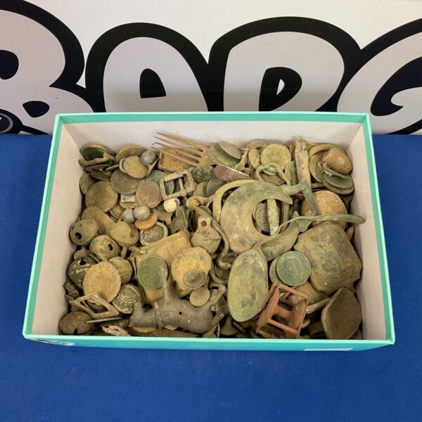 Metal detector finds collection featuring coins and a small bell.
