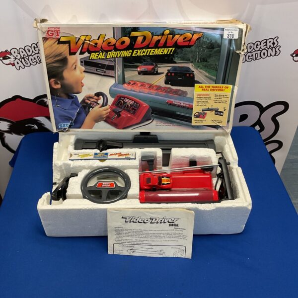 Boxed Sega Video Driver G1 steering wheel, retro gaming accessory.