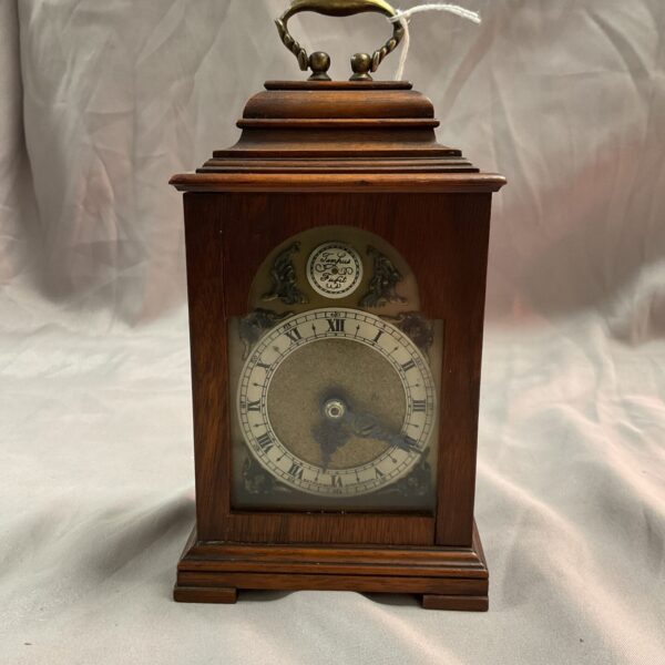 Vintage Nathan and Co mantle clock with Roman numerals.