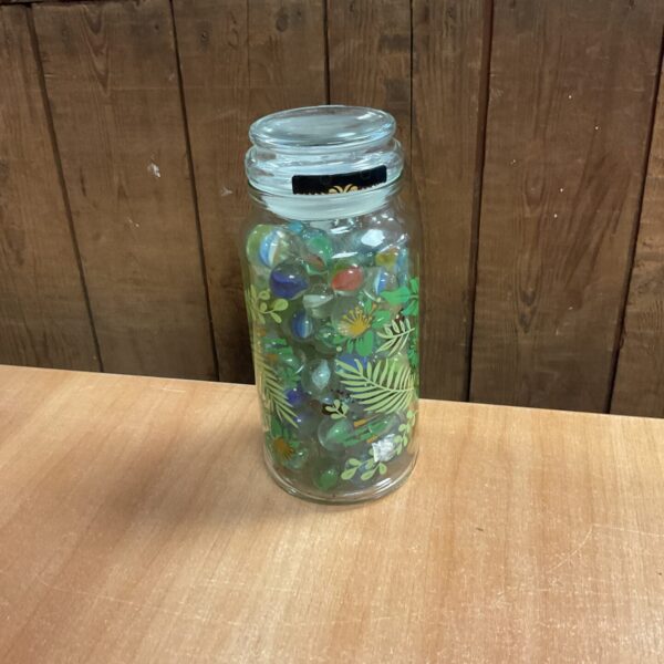 Close-up of colourful vintage marbles in a glass jar.