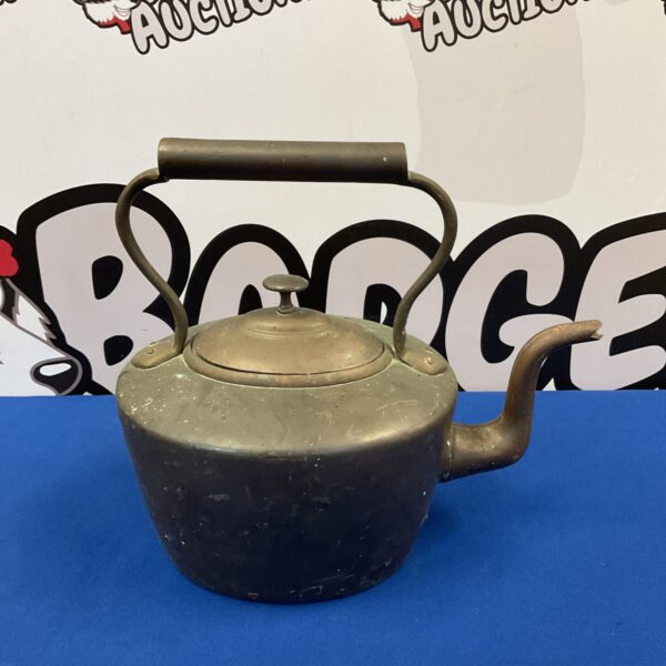 Antique copper kettle with curved handle and spout.
