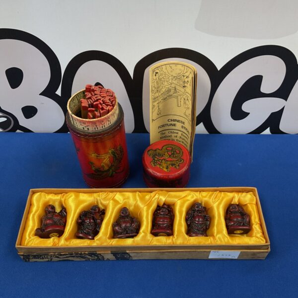 Vintage Chinese fortune sticks set with miniature Buddha figurines.