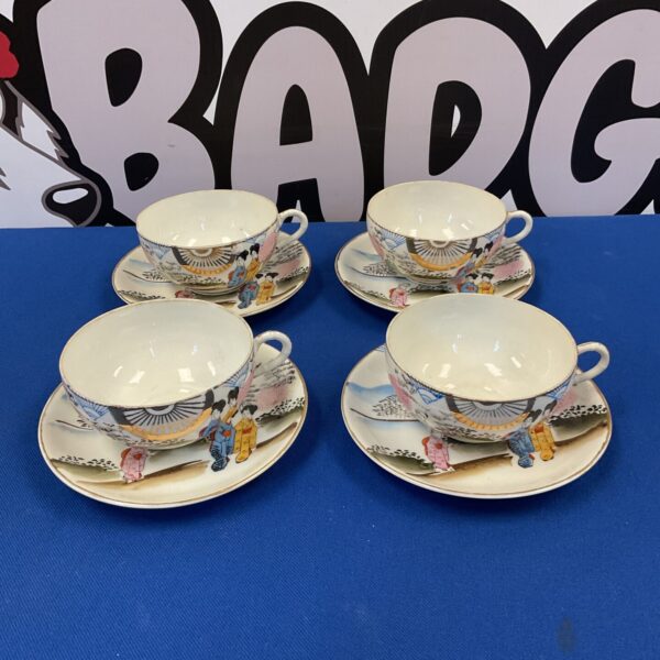 Vintage Japanese porcelain teacup set with colourful landscape design.