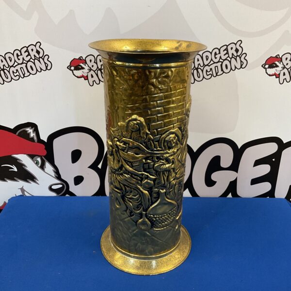 Vintage brass stick stand with detailed tavern scene design.