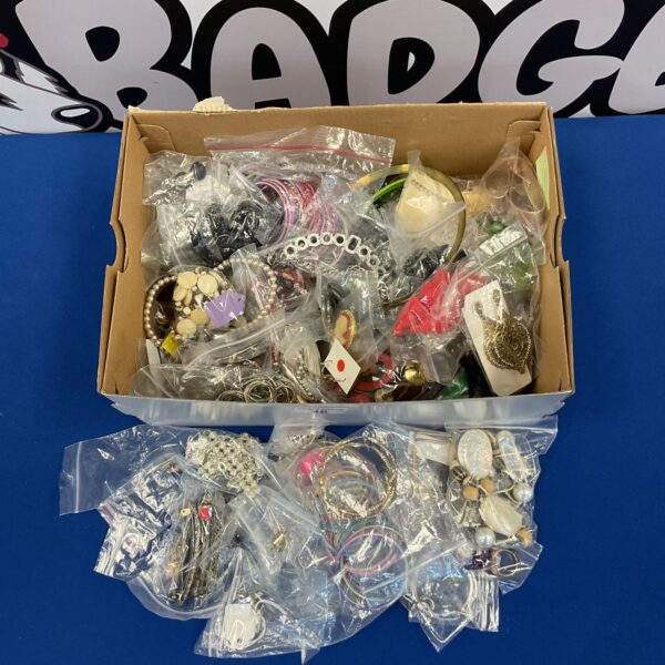 Costume jewellery lot with rings, bracelets, and necklaces on display.