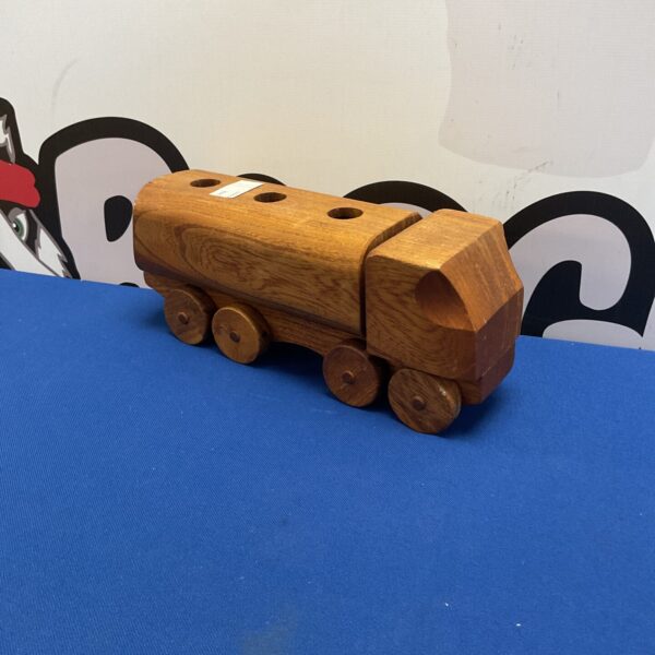 Side view of a handmade wooden truck, folk art toy.