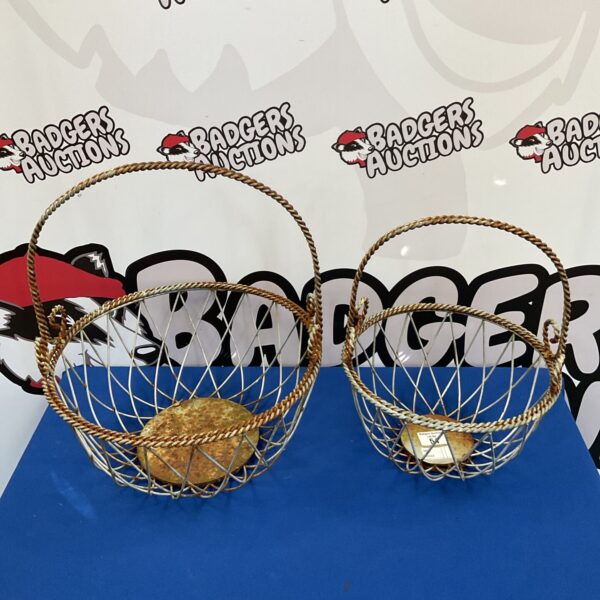 Pair of ornate metal hanging baskets with woven design.