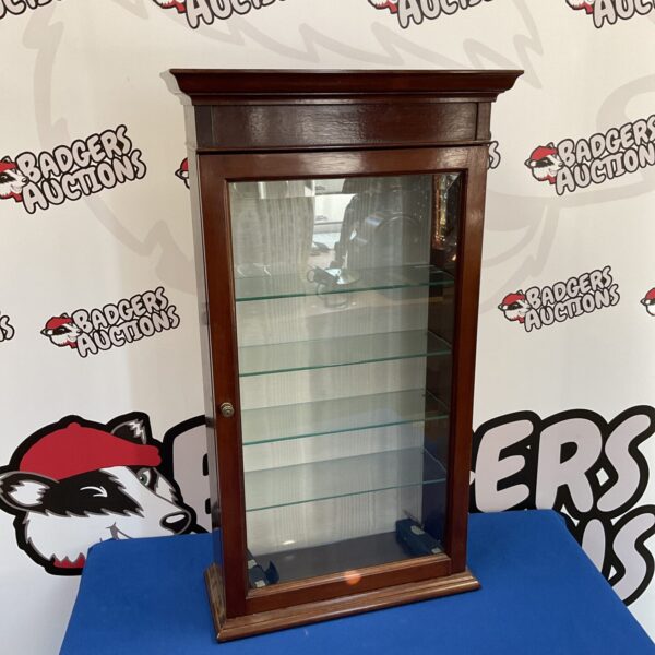 Vintage mahogany display cabinet with glass door and shelves.