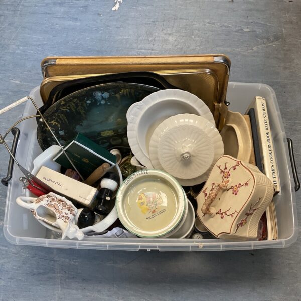 Mixed china lot with serving trays and cheese cloche on display.