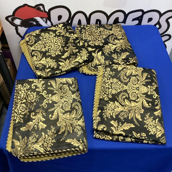 Set of four large gold and black patterned cushion covers for home decor.