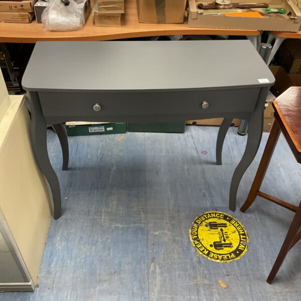 Grey console table in a hallway setting, offering storage and style.