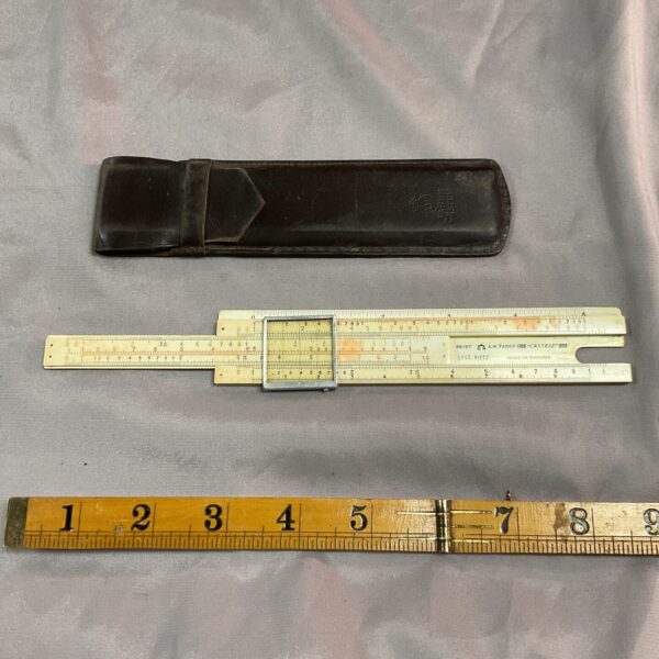 Vintage Faber Castell calculator in leather case, antique calculating tool.