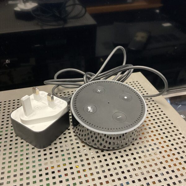 Black Amazon Alexa smart speaker with power adapter shown.