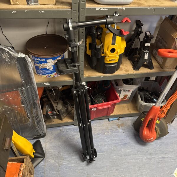 Adjustable bicycle maintenance stand in a workshop setting.
