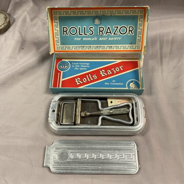 Vintage Rolls razor in original box, collectible antique shaving tool.