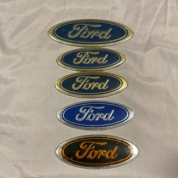 Five vintage Ford car badges for collectors and restoration.