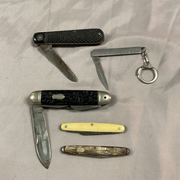 Vintage pocket knife lot with bone handles and folding blades.