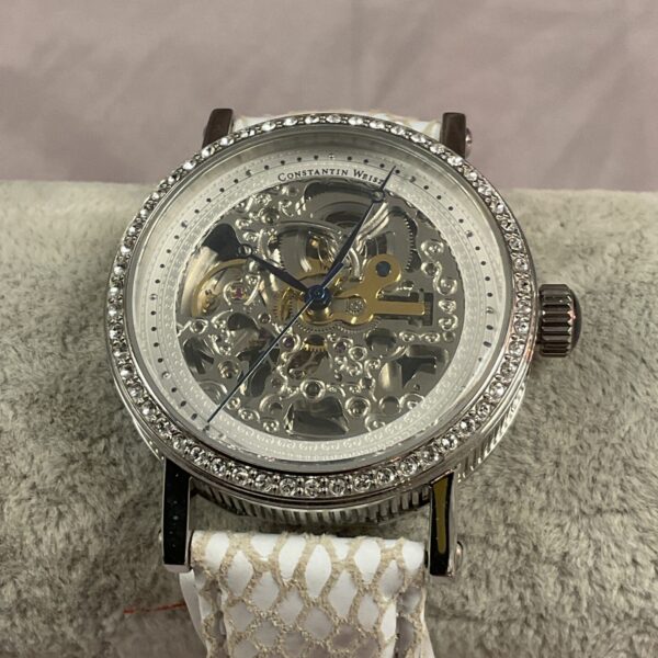 Elegant Constant Weiss automatic watch with skeleton dial and crystal case.