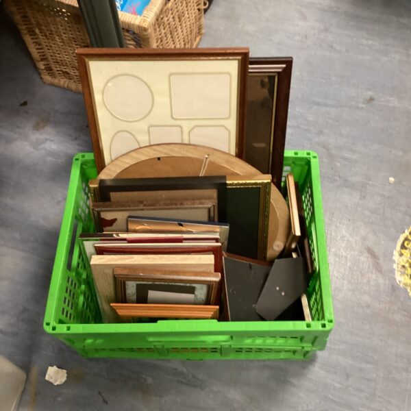 Crate filled with a diverse lot of mixed picture frames.
