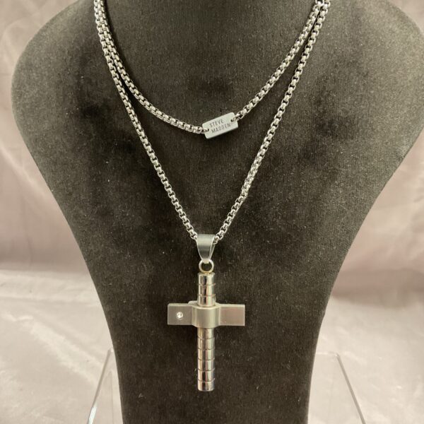 Steve Madden steel cross pendant necklace on a chain.