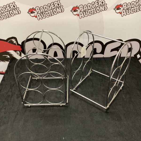 Two chrome wine racks holding five bottles each.