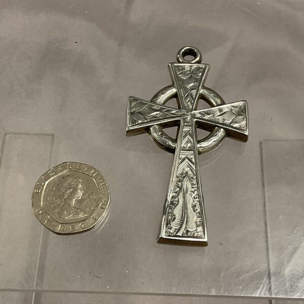 Antique Victorian silver Celtic cross pendant with intricate detailing.