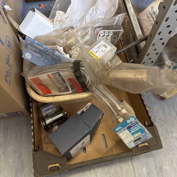 Tray of mixed plumbing supplies and fittings for DIY projects.