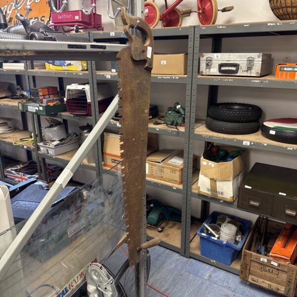 Large vintage timber saw with a rusted blade, ideal for collectors.