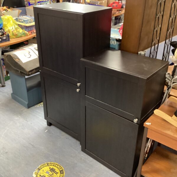 Set of black Ikea cabinets for modern storage.