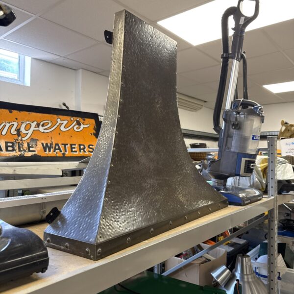 Vintage brass fire hood with a classic patina.