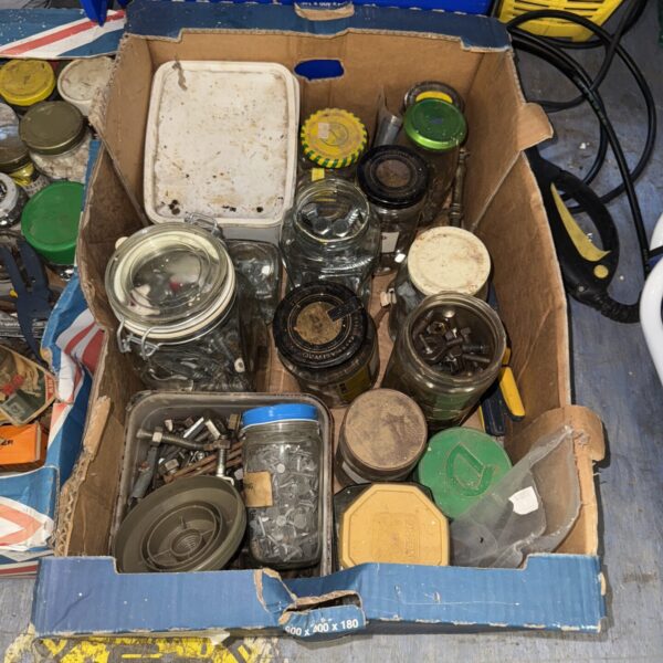 Assorted nuts, bolts, and screws in a mixed hardware lot.