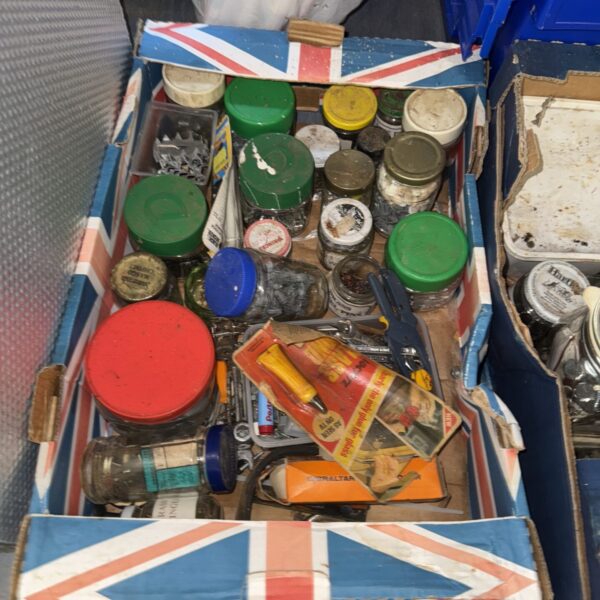 Assorted nuts, bolts and hardware in a shed clearance lot.