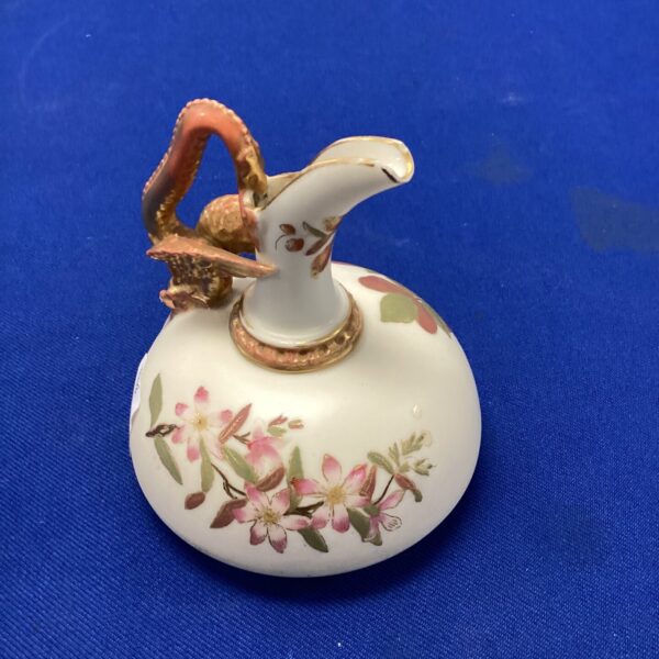 Antique Royal Worcester jug with hand-painted floral design.
