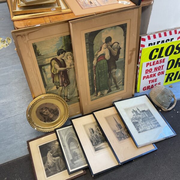 Collection of vintage and antique prints and etchings in ornate frames.