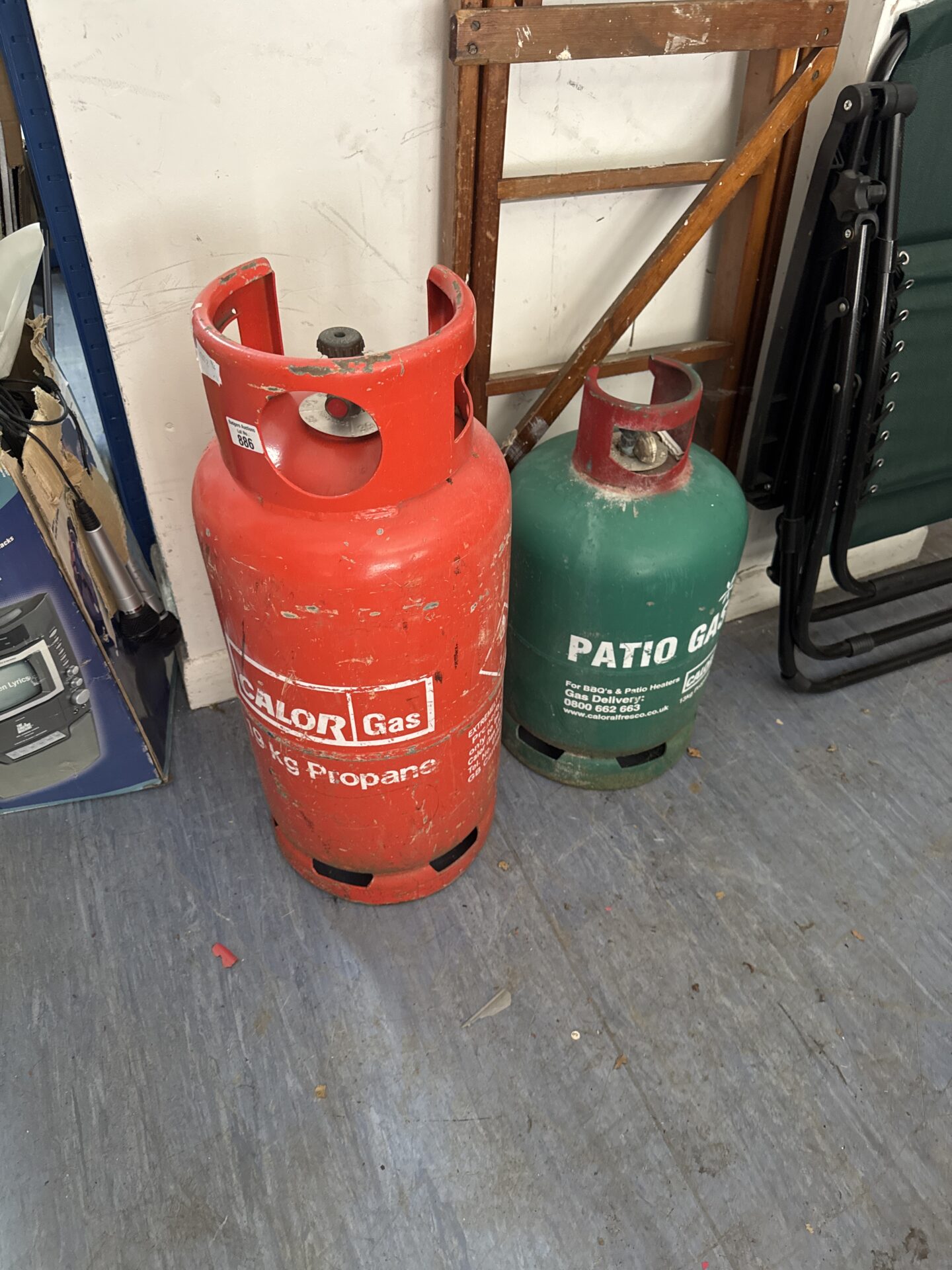 1065 Two patio gas canisters – orange one has some contents, green showing empty