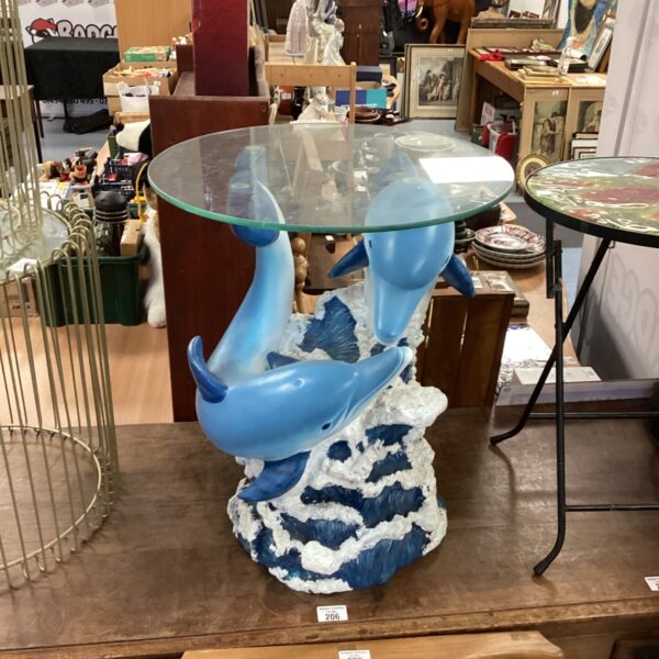 Unique dolphin side table with wave base and glass top.
