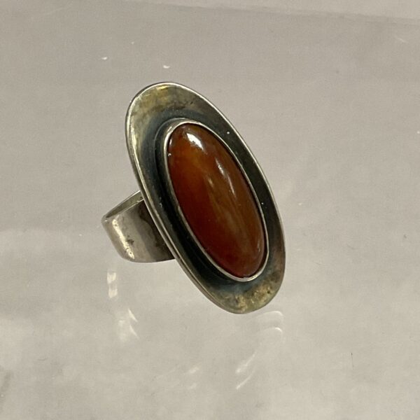 Close-up of vintage sterling silver ring with amber stone.