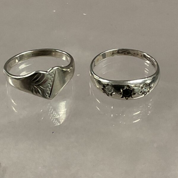 Silver ring with sculpted band and vintage detailing.