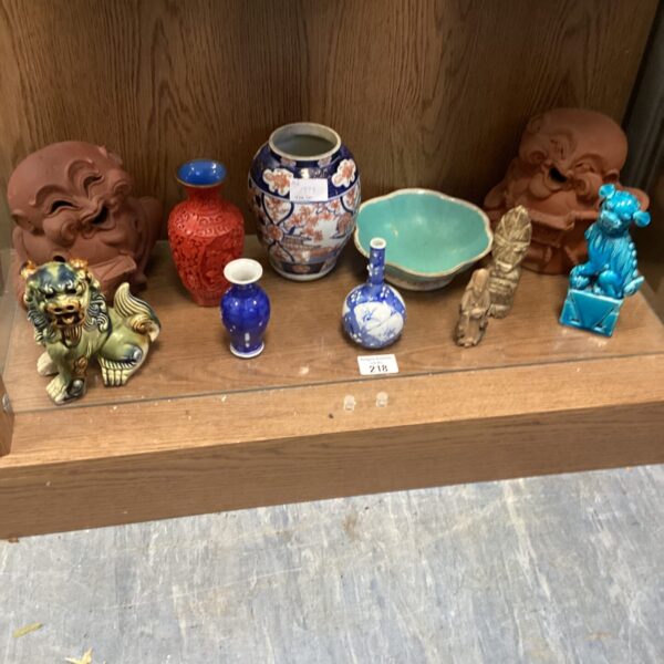 Collection of oriental collectibles including Foo Dogs and porcelain.