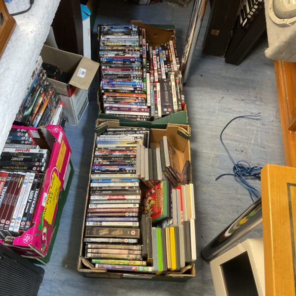Assorted DVDs in trays, a mixed lot of films for collectors.