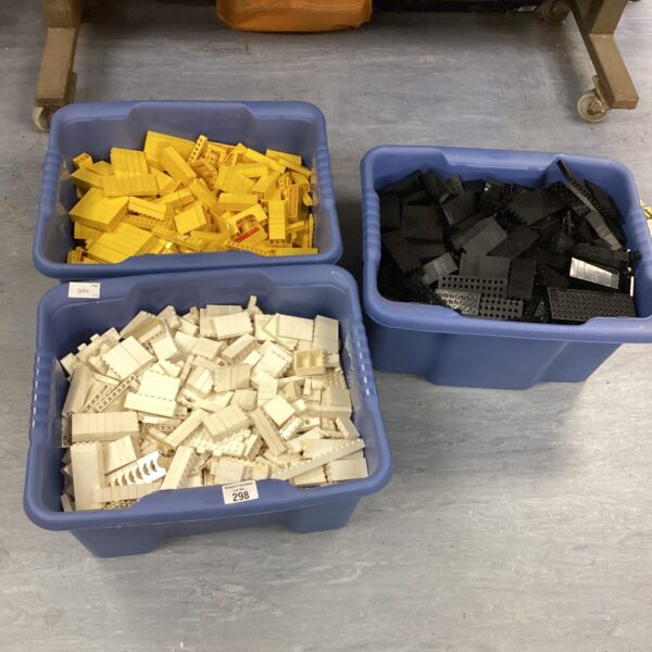 Sorted vintage Lego bricks in white, yellow, and black boxes.