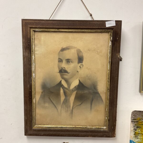 Antique framed portrait of a gentleman in vintage clothing.