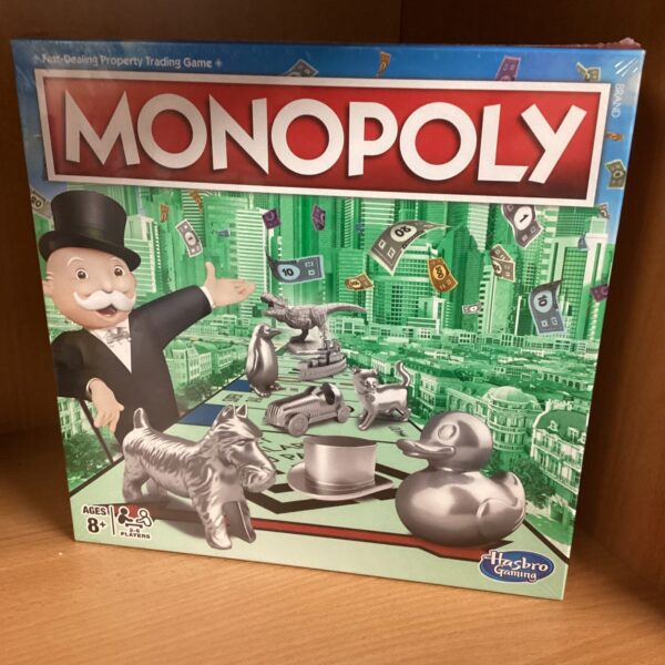 Vintage Hasbro Monopoly board game with tokens and board.