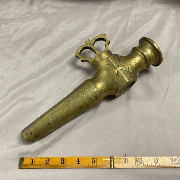 Antique French wine spigot with ruler for scale.